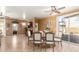 Inviting dining room features wood-look tile flooring and sliding glass doors to the backyard at 16510 W Tether Trl, Surprise, AZ 85387