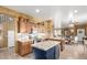 Open concept kitchen with wood cabinets, granite counters, and large center island at 16510 W Tether Trl, Surprise, AZ 85387