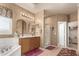 Main bathroom with separate tub and shower, dual sinks, and private toilet room at 16510 W Tether Trl, Surprise, AZ 85387