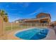 Sparkling pool surrounded by a well-maintained yard with fencing and palm trees at 16510 W Tether Trl, Surprise, AZ 85387
