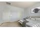 Cozy bedroom with carpet, a full bed with a striped comforter, and modern wall art at 18658 N Desert Willow Dr, Maricopa, AZ 85138