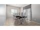 Bright dining room features tile floors, a large window, and modern table with stylish chairs at 18658 N Desert Willow Dr, Maricopa, AZ 85138
