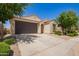 Inviting single-story home with a two-car garage, neutral stucco, and neat landscaping at 18658 N Desert Willow Dr, Maricopa, AZ 85138