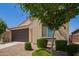 Charming single-story home featuring a two-car garage, neutral stucco, and well-manicured landscaping at 18658 N Desert Willow Dr, Maricopa, AZ 85138