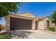 Charming single-story home featuring a two-car garage, neutral stucco, and well-manicured landscaping at 18658 N Desert Willow Dr, Maricopa, AZ 85138