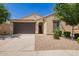 Inviting single-story home with a two-car garage, neutral stucco, and neat landscaping at 18658 N Desert Willow Dr, Maricopa, AZ 85138