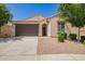 Inviting single-story home with a two-car garage, neutral stucco, and neat landscaping at 18658 N Desert Willow Dr, Maricopa, AZ 85138
