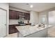 Gourmet kitchen with granite island, stainless steel appliances, and stylish dark wood cabinets at 18658 N Desert Willow Dr, Maricopa, AZ 85138