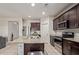 Well-lit kitchen with granite counters, stainless steel appliances, and dark cabinets perfect for cooking at 18658 N Desert Willow Dr, Maricopa, AZ 85138
