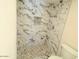Bathroom featuring updated shower with decorative marble tile and mosaic tile floor at 2121 W Union Hills Dr # 104, Phoenix, AZ 85027