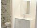 Beautiful bathroom featuring updated vanity, marble tiled walls and mosaic tiled shower floor at 2121 W Union Hills Dr # 104, Phoenix, AZ 85027