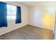 Comfortable bedroom with a large window, hardwood floors, and neutral paint, offering a soothing atmosphere at 2121 W Union Hills Dr # 104, Phoenix, AZ 85027