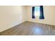 This is a bedroom with vinyl plank flooring and a window with coverings at 2121 W Union Hills Dr # 104, Phoenix, AZ 85027