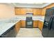 Bright kitchen showcasing updated cabinets, granite countertops, and stainless steel appliances at 2121 W Union Hills Dr # 104, Phoenix, AZ 85027