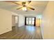 Spacious living room with modern ceiling fan, neutral paint, and a large sliding glass door to the back at 2121 W Union Hills Dr # 104, Phoenix, AZ 85027