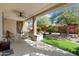 Inviting back patio with a ceiling fan, outdoor seating, and a landscaped backyard at 21867 N 263Rd Dr, Buckeye, AZ 85396
