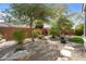 Picturesque backyard featuring desert landscaping, mature trees, and a tranquil seating area at 21867 N 263Rd Dr, Buckeye, AZ 85396