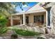 Serene backyard with a covered patio, artificial grass, and desert landscaping at 21867 N 263Rd Dr, Buckeye, AZ 85396