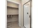 Modern bathroom featuring a glass-enclosed shower and a large walk-in closet at 21867 N 263Rd Dr, Buckeye, AZ 85396