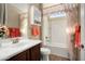 Well-lit bathroom with a bathtub, shower combination, and charming floral curtains at 21867 N 263Rd Dr, Buckeye, AZ 85396