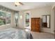 Bedroom featuring neutral carpet, backyard views, and a glass paneled door leading to the patio at 21867 N 263Rd Dr, Buckeye, AZ 85396