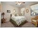 Comfortable bedroom with neutral tones, ceiling fan, and rattan decor for a peaceful atmosphere at 21867 N 263Rd Dr, Buckeye, AZ 85396