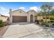 Well-maintained single-story home with a desert landscape, a two-car garage, and a charming entry at 21867 N 263Rd Dr, Buckeye, AZ 85396