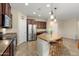 Bright kitchen featuring a stainless steel fridge, island with seating, and lots of cabinet space at 21867 N 263Rd Dr, Buckeye, AZ 85396