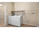 Functional laundry room equipped with a washer, dryer, and ample shelving for storage at 21867 N 263Rd Dr, Buckeye, AZ 85396