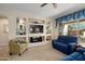 Cozy living room featuring built-in shelving, plush seating, and natural light at 21867 N 263Rd Dr, Buckeye, AZ 85396