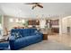 Open-concept living room with tile flooring, open layout and a view into the kitchen at 21867 N 263Rd Dr, Buckeye, AZ 85396