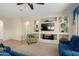 Comfortable living room with a large television, built-in shelving, and plush seating at 21867 N 263Rd Dr, Buckeye, AZ 85396