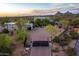 An aerial view of a luxurious home with a large driveway, desert landscaping, and a gated entrance at 22500 N 97Th St, Scottsdale, AZ 85255