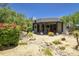 View of the backyard featuring desert landscaping, patio, and mature trees at 22500 N 97Th St, Scottsdale, AZ 85255