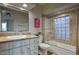 Bathroom boasts a tub with tile surround and glass block window allowing for natural light at 22500 N 97Th St, Scottsdale, AZ 85255