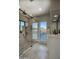 Walk-in shower featuring a window with a mountain view, neutral tiling, and a modern double vanity at 22500 N 97Th St, Scottsdale, AZ 85255