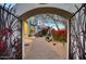 A walkway featuring desert landscaping, leading to a beautifully designed home with a gate at 22500 N 97Th St, Scottsdale, AZ 85255