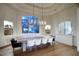 Elegant dining room with large window, modern chandelier, and seating for ten at 22500 N 97Th St, Scottsdale, AZ 85255