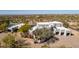 Aerial view of a modern home highlighting the desert landscape and a private driveway with a gate at 22500 N 97Th St, Scottsdale, AZ 85255