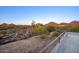 This property features desert landscaping, fencing, and mountain views in the background at 22500 N 97Th St, Scottsdale, AZ 85255