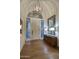 Elegant foyer with hardwood floors, a decorative mirror, and a unique chandelier at 22500 N 97Th St, Scottsdale, AZ 85255