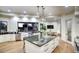 Modern kitchen with stone countertops, an oversized island, and a beautiful view at 22500 N 97Th St, Scottsdale, AZ 85255