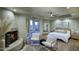 Serene main bedroom with fireplace, sitting area, and natural light at 22500 N 97Th St, Scottsdale, AZ 85255