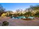 Backyard pool featuring mature landscaping and a stone deck at 22500 N 97Th St, Scottsdale, AZ 85255