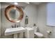 Contemporary powder room with a round mirror, a modern sink, and a sleek design at 22500 N 97Th St, Scottsdale, AZ 85255
