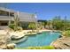 Lush backyard oasis with pool, rock features, and desert landscaping at 22500 N 97Th St, Scottsdale, AZ 85255