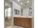 Bathroom featuring double sinks with wood cabinets and large mirror at 23649 W Watkins St, Buckeye, AZ 85326