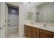 Well-lit bathroom featuring double sinks and a shower with white tile surround at 23649 W Watkins St, Buckeye, AZ 85326