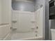 Bright bathroom showcasing a clean, white shower-tub combo with shelving at 23649 W Watkins St, Buckeye, AZ 85326