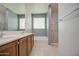 Bathroom with dual sink vanity, soaking tub, shower, and tile flooring at 23649 W Watkins St, Buckeye, AZ 85326